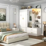 A white wardrobe with four doors, a mirrored section with hooks and shelves, and drawers below.