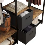 Close-up of a clothing rack with shelves, hanging rods, and two fabric drawers.