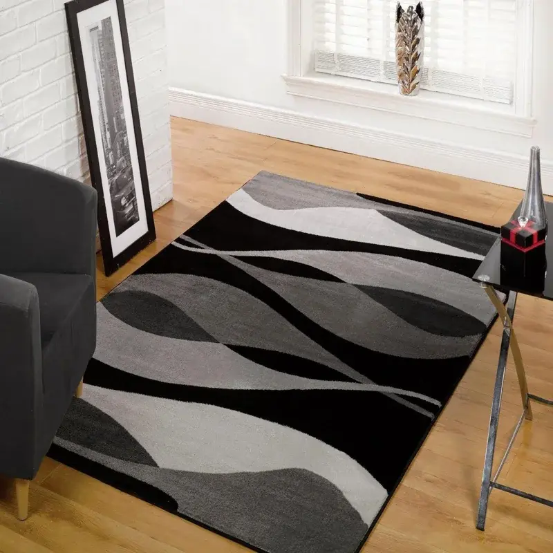 Modern area rug with a dynamic, abstract pattern in black, white, and gray