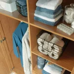 Well-organized closet with items neatly folded and stored in baskets.