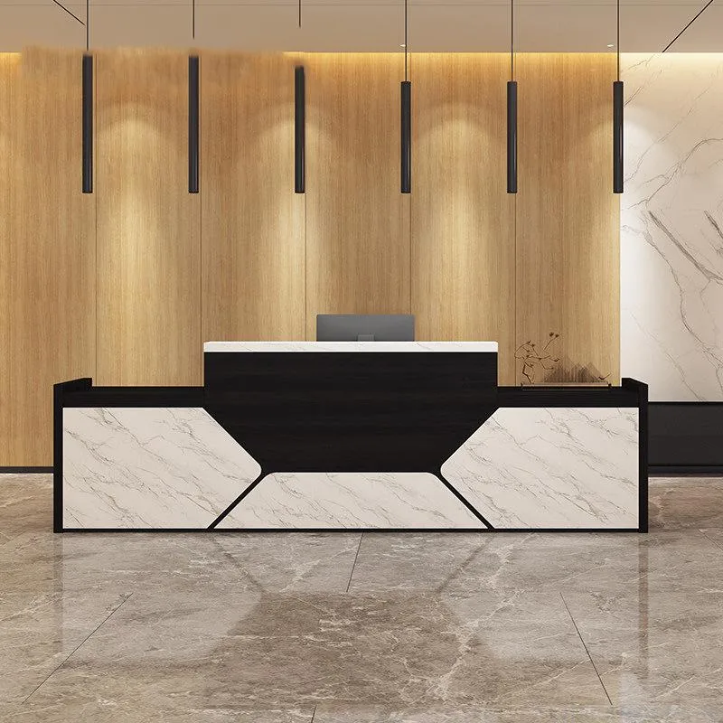 A contemporary and stylish custom made reception desk with a black wood grain finish and white marble-look front panels.