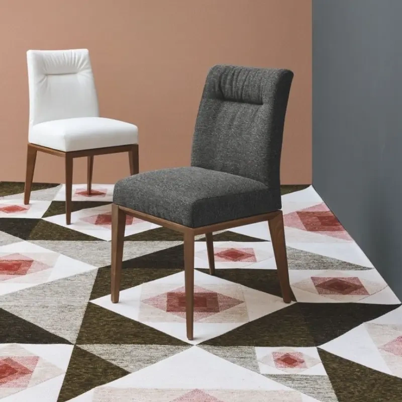 Two elegantly tailored modern dining chairs, emphasizing the custom made chair upholstery.